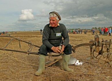 Gerard King rests with a much-deserved bottle of Guinness after finishing ploughing