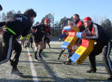 Paul O'Connell looks on as Donncha O'Callaghan into the tackle bags at Garryowen RFC in Dooradoyle, Co Limerick today.