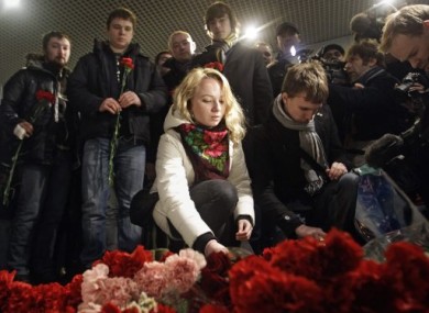 People lay flowers at the scene of last week's explosion at Domodedovo airport.