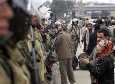 Egytian soldiers line up to form a guard around anti-Mubarak protesters in Cairo, Egypt, on 5 February, 2011.