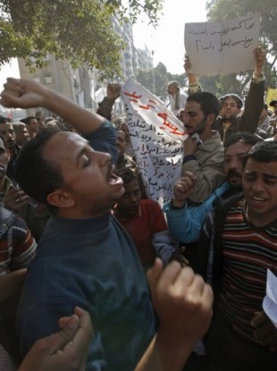 Workers demanding higher wages protest outside a national TV building in Cairo today.