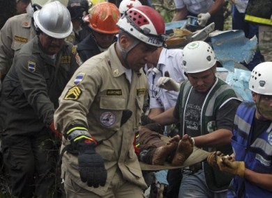 Rescue workers remove bodies from the scene of the crash.