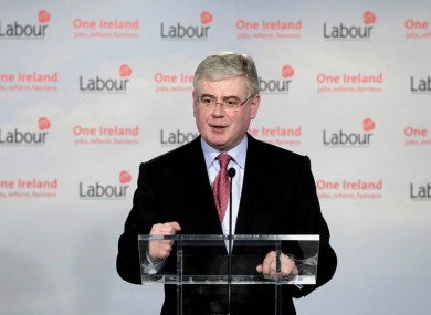 Labour leader Eamon Gilmore has been reminded that his party still has the option of entering opposition, as talks between his team and that of Enda Kenny continue.