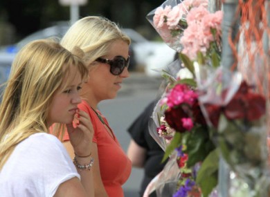 Citizens visit a devastated site to mark last week's earthquake in Christchurch.
