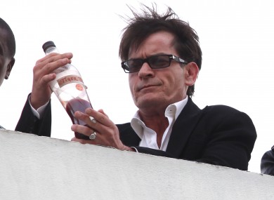 Charlie Sheen drinks from a bottle labelled 'tiger blood' in LA last week. The actor is to kick off a live tour, though the contents of the show are unknown.