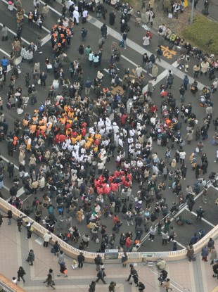 People gather outside Sendai station after a powerful earthquake hit northern Japan on Friday