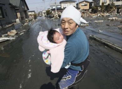 Upon hearing of new tsunami warning, a father tries to flee to safety with his just-reunited four-month-old daughter.