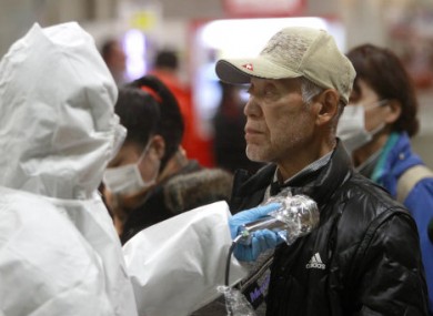 An evacuee is screened for radiation exposure in the Fukushima prefecture, Japan, yesterday.
