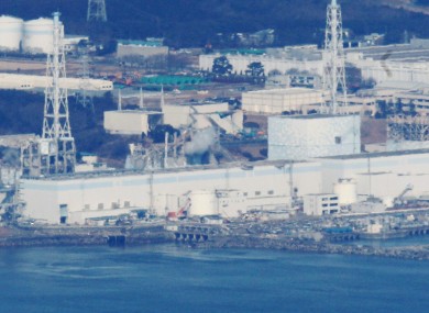An aerial photograph of the Fukushima I plant, taken while engineers attempted to drop water on it from helicopters.