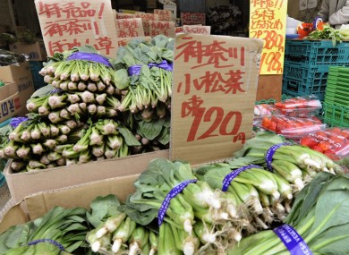 A greengrocer in Tokyo sells spinach from the Kanagawa prefecture - which has not been affected by radioactivity. Most food from the Fukushima prefecture has been taken off the market.