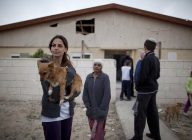Israeli citizens stand next to a house in Beersheba, damaged by rockets fired by Palestinian militants today.