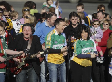 Ger Corrigan (2nd left) and RTÉ presenter Derek Mooney (centre) direct the residents of Moneygall as they shoot the music video for the Corrigan Brothers' new song, 'Welcome Home President Barack Obama', yesterday.
