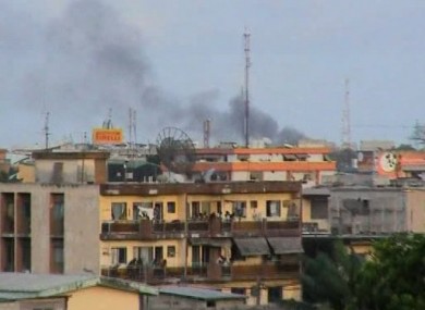 In this frame taken from the TV, the rooftops in the Triechville neighbourhood can be seen among plumes of black smoke in Abidjan, Ivory Coast, Thursday March 31