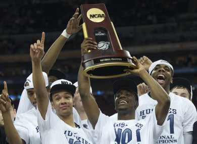Kemba Walker (centre) holds up the championship trophy with his Connecticut teammates.