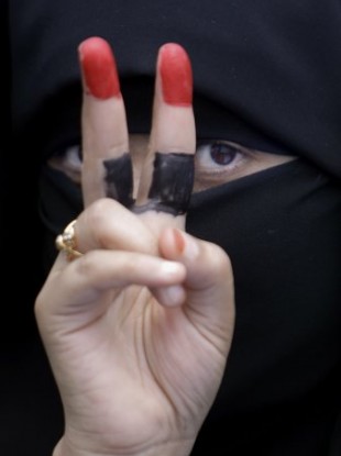 A female anti-government protestor displays the victory sign with her fingers painted with the colours of her national flag during a demonstration demanding the resignation of Yemeni President Ali Abdullah Saleh, in Sanaa,Yemen, Tuesday, April 5.