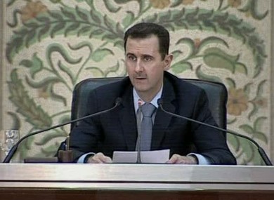 Syrian president Bashar Assad makes a speech in front of his cabinet in Damascus.