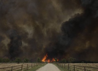 Smoke rises from an uncontrolled wildfire burning near Possum Kingdom, Texas.
