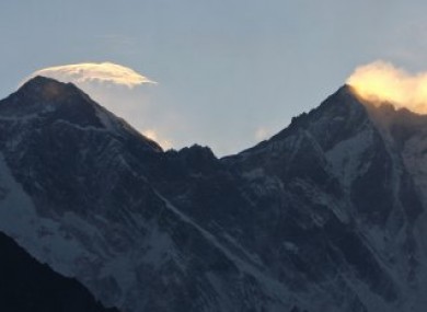 Clouds hover above the world's highest peak, Mount Everest.