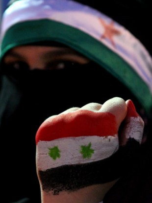 A Syrian protester at a demonstration in Jordan demanding Assad's resignation.