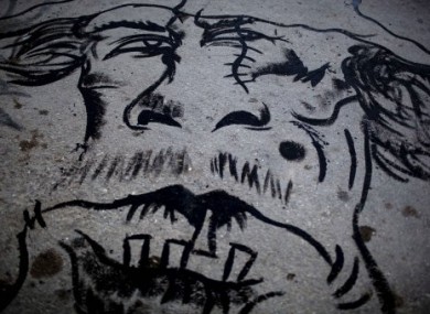 Graffiti depicting Col Gaddafi as a beast seen downtown in Benghazi, Libya, on 16 May 2011.