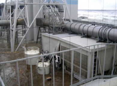 File photo from 11 March 2011 of tsunami waves receding from the Fukushima power station complex.