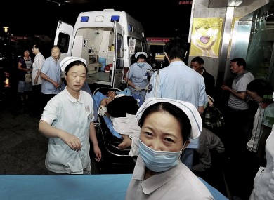An injured man from a Foxconn factory, on a stretcher, arrives at a hospital in Chengdu in China's Sichuan province.