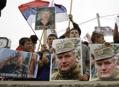 Bosnian Serbs hold Serbian flags and photos of Ratko Mladic during a protest today against his extradition in Kalinovik, Bosnia.