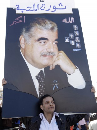 A supporter holds aloft a protrait of Hariri