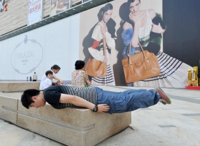 A man planks on a street in Shenyang, China. A New Zealand school has been criticised for organising a planking competition for its students.