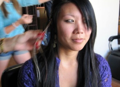 Kim Shanks gets feather extensions clipped into her hair at MiraBella Salon and Spa in Boise, Idaho