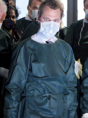 German Health Minister Daniel Bahr wears protective clothes during a visit to a German hospital on Sunday.