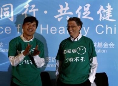 Baidu CEO, Robin Li, left, and Microsoft founder Bill Gates, right, smile wearing green t-shirts with the words