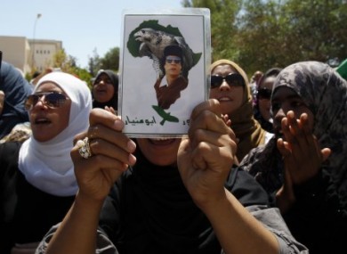 Libyan students chant pro-Gaddafi slogans outside a damaged university building in Tripoli, Libya, today.
