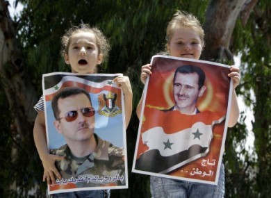 Syrian girls hold posters of President Assad as a show of support in Beirut.