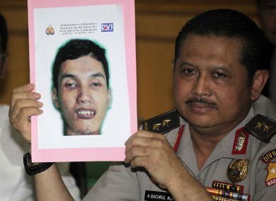 Indonesian National Police spokesperson Maj.Gen. Anton Bachrul Alam holds up a picture of Muhammad Syarif, who blew himself at a mosque inside a police compound on April 15