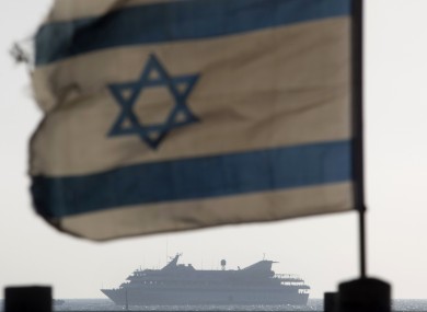 An Israeli flag and in the distance the Mavi Marmara which was stormed by Israeli soldiers in a bloody confrontation last year. (File photo)