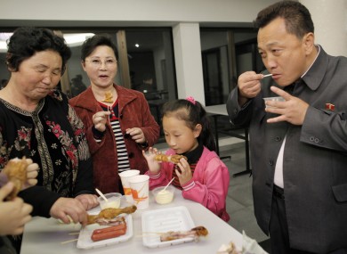 A North Korean family eats at a fast food restaurant in Pyongyang. North Korea's food shortage has become so intense that many have been forced to eat grass.