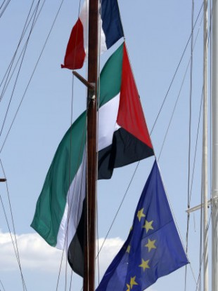 French and Palestinian flags flying on a ship moored in Piraeus yesterday.