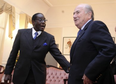 FIFA President Sepp Blatter, right, is greeted by Zimbabwean President Robert Mugabe, during his visit to Zimbabwe on Monday.