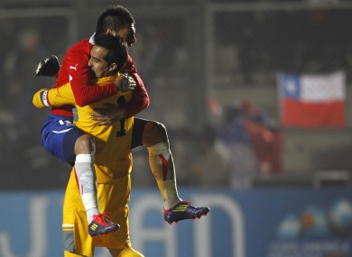 Chile's Gonzalo Jara celebrates with goalkeeper Claudio Bravo.