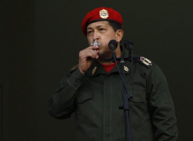 President Chavez kisses his crucifix while addressing supporters in Caracas.