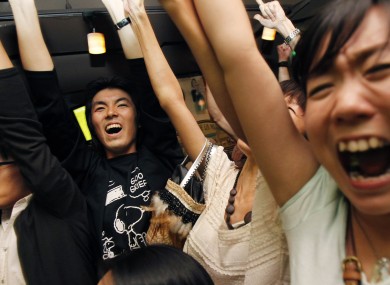 Japanese fans in Tokyo celebrate their country's World Cup triumph.