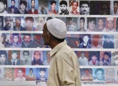 A man walks past photos of missing people during a demonstration organised by the Association of Parents of Disappeared Persons last month.
