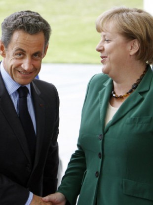 German Chancellor Angela Merkel, right, welcomes French President Nicolas Sarkozy in Berlin Wednesday, July 20,