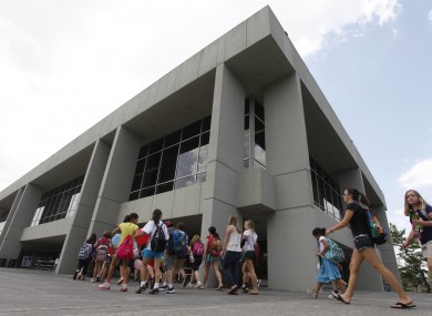 Virginia Tech campers walk into Dietrick Hall after a lockdown of the campus was lifted at the school.