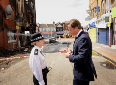 Prime Minister David Cameron talks to Acting Borough Commander Superintendent Jo Oakley in Croydon, south London, yesterday.