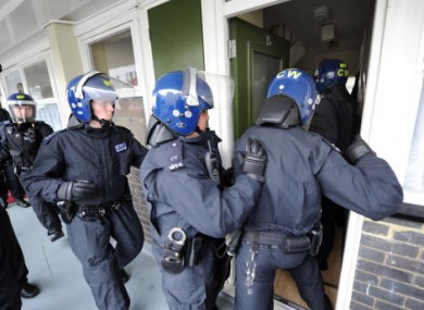 Metropolitan Police officers carry out a raid on a property on the Churchill Gardens estate in Pimlico during Operation Woodstock, London.