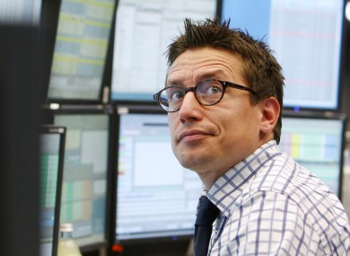A trader watches his screens at the stock market in Frankfurt, where the DAX index fell below 6,000 points today.