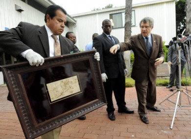 Detectives from the Los Angeles Sheriff's office show the recovered 17th century sketch.
