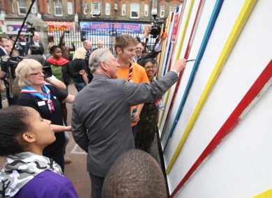 The Prince of Wales paints on a wall in Croydon as he and the Duchess of Cornwall visited the area blighted by the recent riots.
